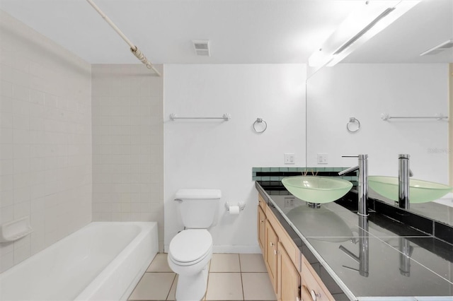 bathroom featuring tile patterned flooring, vanity, and toilet