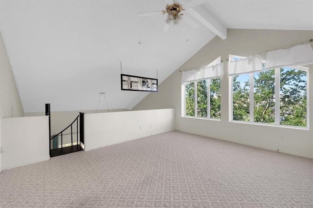 interior space with carpet, ceiling fan, and lofted ceiling with beams