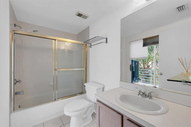 full bathroom with tile patterned floors, vanity, toilet, and shower / bath combination with glass door