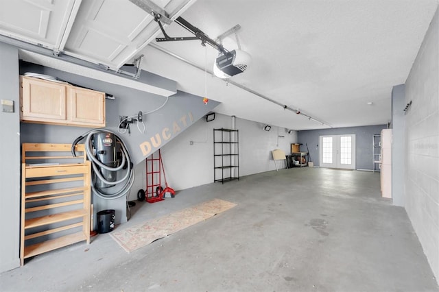 garage featuring french doors and a garage door opener