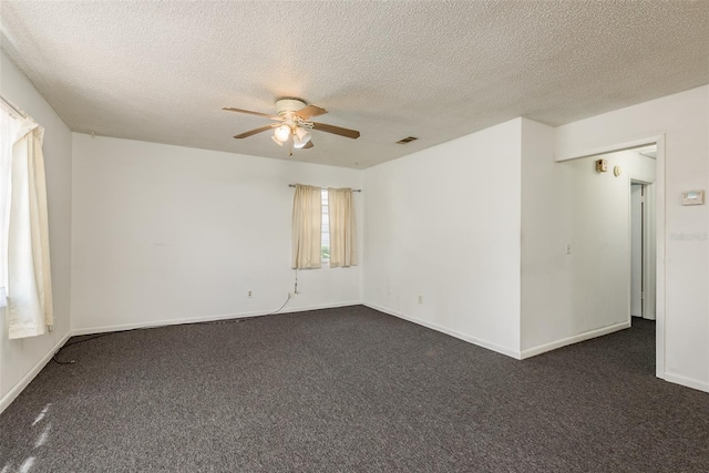 carpeted spare room with ceiling fan and a textured ceiling