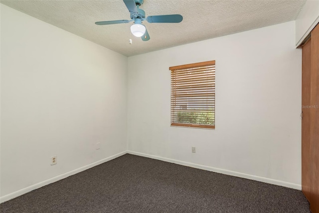 carpeted spare room with ceiling fan and a textured ceiling