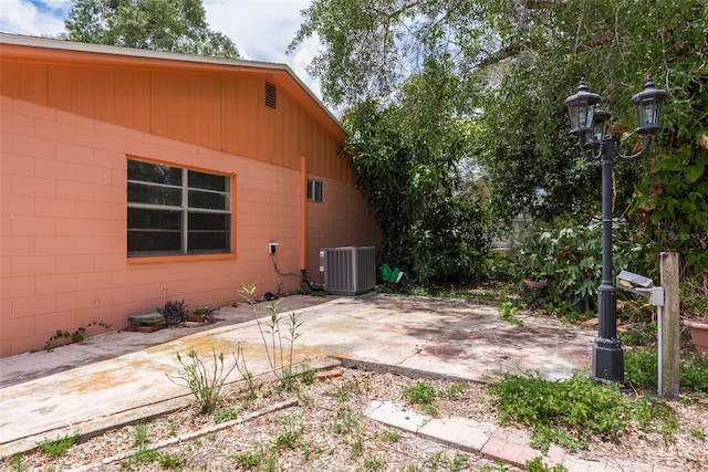 view of side of property with central AC and a patio area