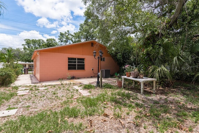 view of side of property with central AC