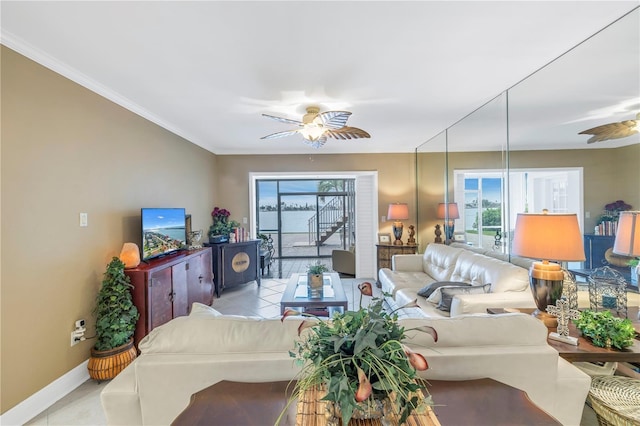 living room featuring ceiling fan, light tile patterned floors, and ornamental molding