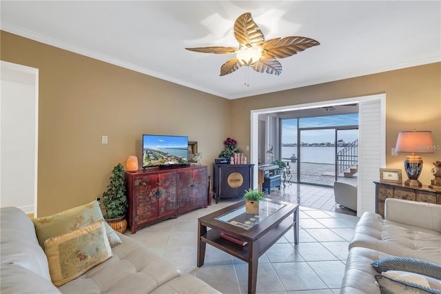 living room featuring ceiling fan, crown molding, and light tile patterned flooring