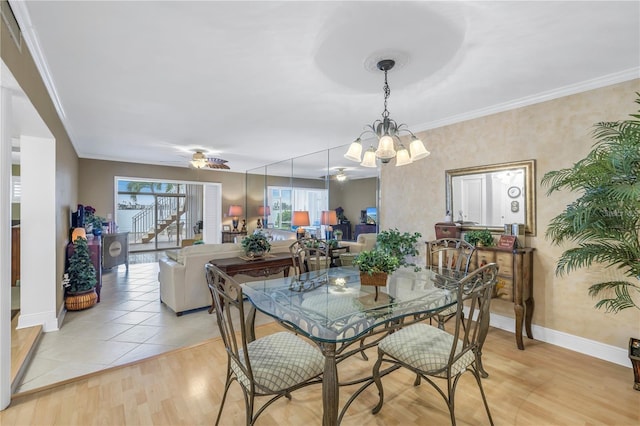 dining area featuring a notable chandelier, ornamental molding, and light hardwood / wood-style flooring