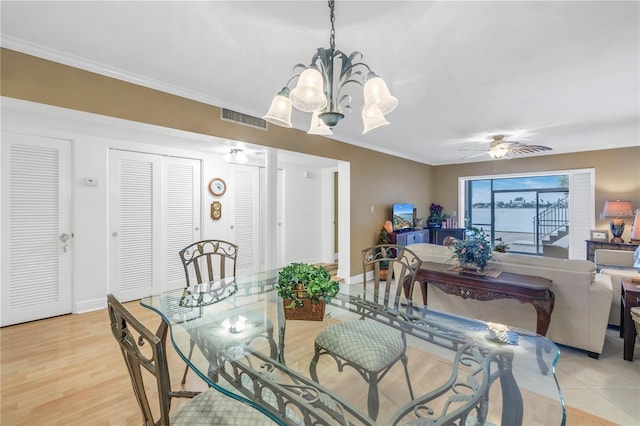 dining room with light hardwood / wood-style floors, ceiling fan with notable chandelier, and ornamental molding