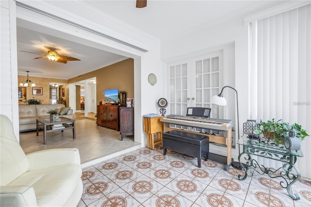 interior space with french doors, ceiling fan with notable chandelier, crown molding, and light tile patterned flooring