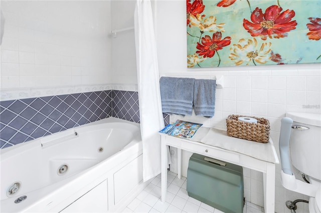 bathroom with tile patterned floors, a tub, and tile walls