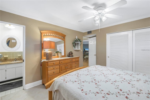 bedroom featuring ensuite bath, ceiling fan, crown molding, sink, and a closet