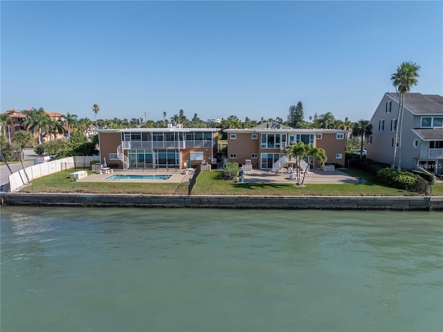 rear view of property with a water view and a patio