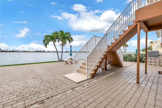 view of patio with a water view