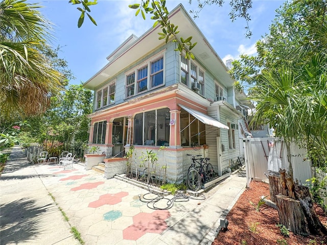 view of front of house with a patio and a sunroom