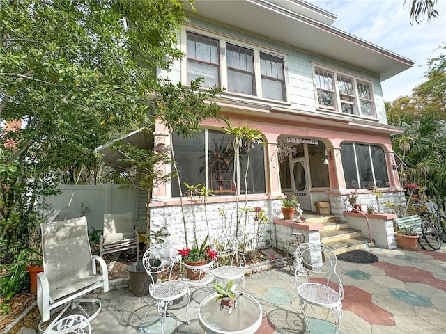 rear view of property featuring a patio area