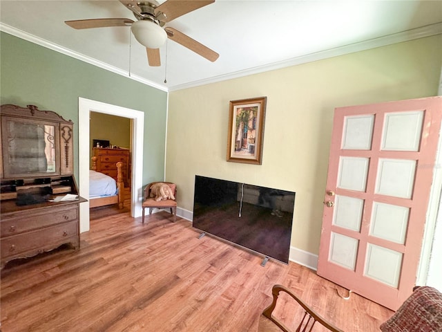 interior space with crown molding, ceiling fan, and light hardwood / wood-style flooring