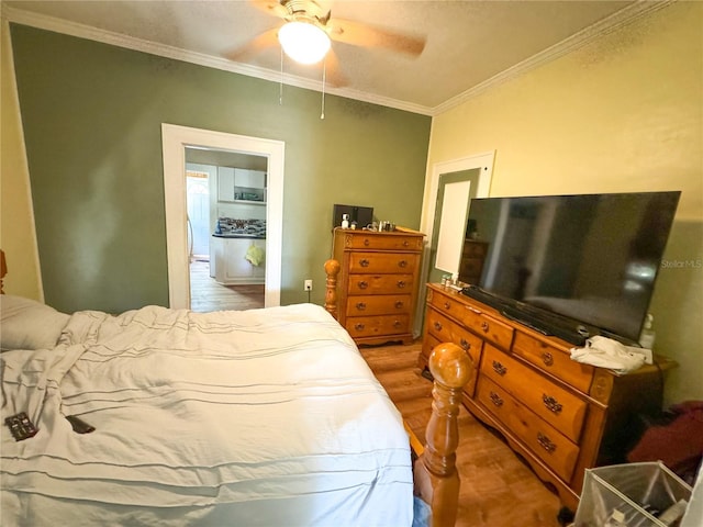 bedroom with crown molding, ceiling fan, and hardwood / wood-style floors