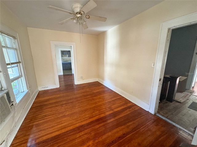 spare room featuring ceiling fan, dark hardwood / wood-style floors, and a healthy amount of sunlight