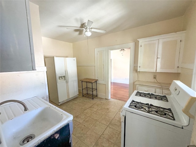 kitchen featuring white cabinetry, white appliances, ceiling fan, and sink