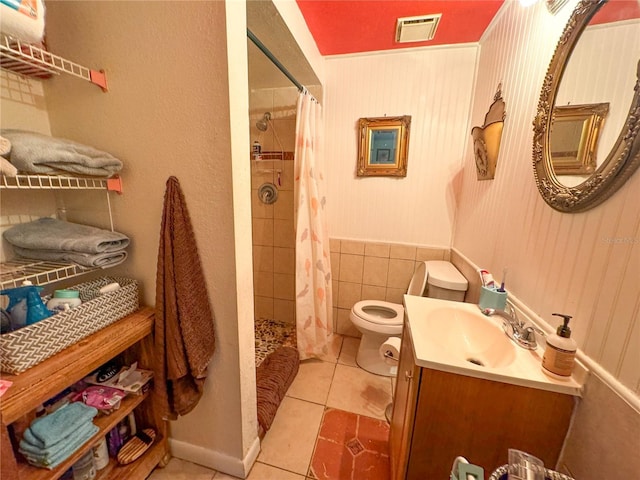 bathroom featuring tile patterned flooring, vanity, a shower with curtain, and toilet