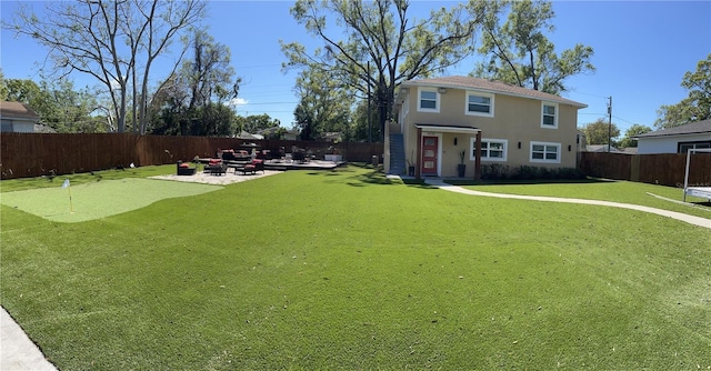 view of yard featuring a patio and a fenced backyard