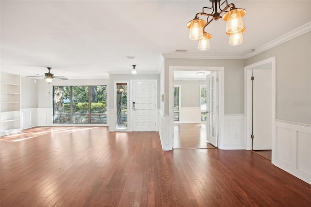 foyer entrance with a healthy amount of sunlight, dark hardwood / wood-style floors, and ornamental molding