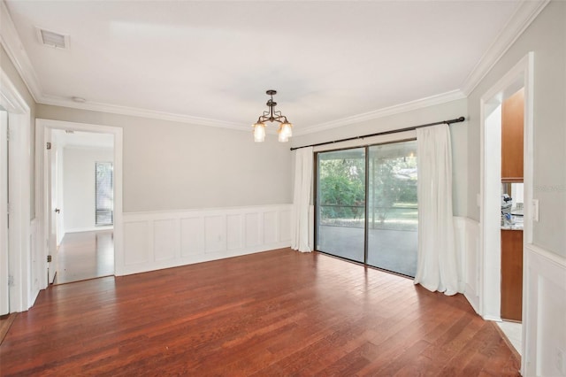 unfurnished room featuring a chandelier, dark hardwood / wood-style floors, and ornamental molding