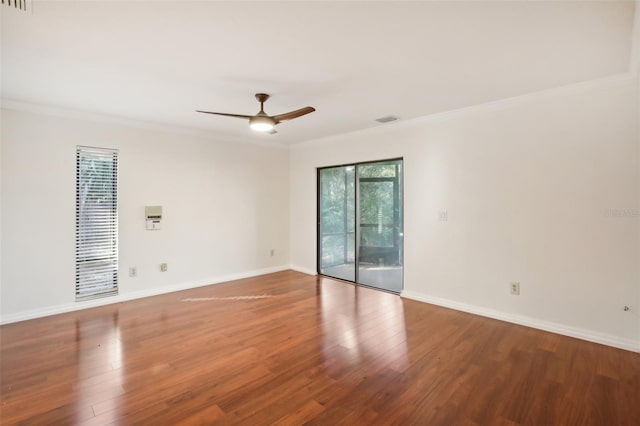 empty room with ceiling fan, crown molding, and wood-type flooring