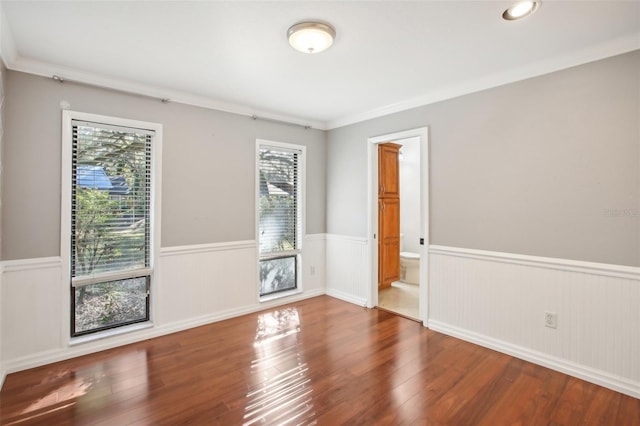 unfurnished room with crown molding and wood-type flooring