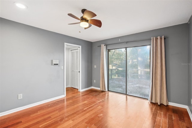 empty room featuring wood-type flooring and ceiling fan