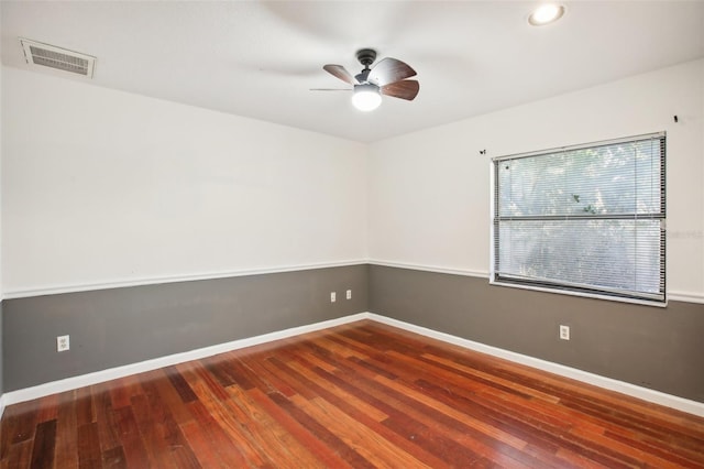 unfurnished room with ceiling fan and dark hardwood / wood-style flooring