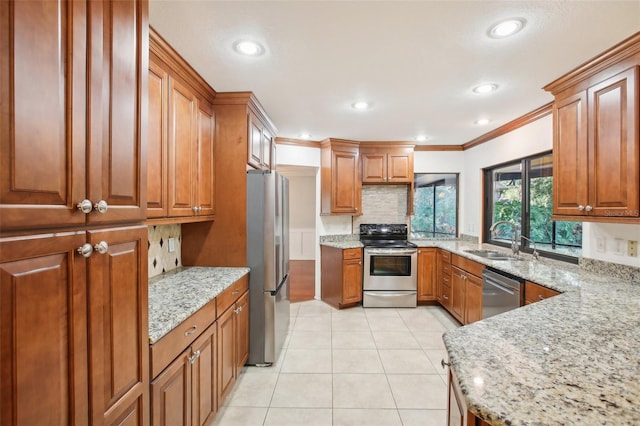 kitchen featuring stainless steel appliances, light stone counters, crown molding, and sink