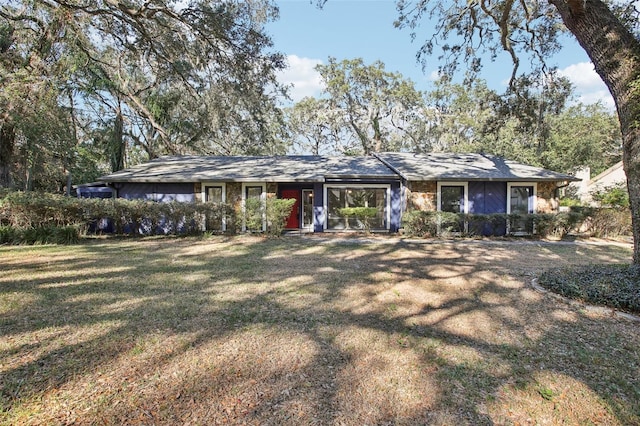 ranch-style home with a front lawn