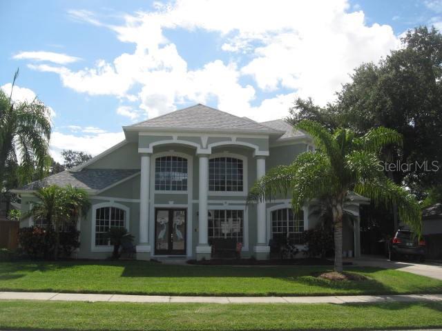 view of front of home with french doors and a front lawn