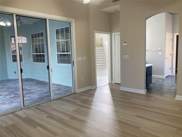 empty room with ceiling fan and light hardwood / wood-style floors