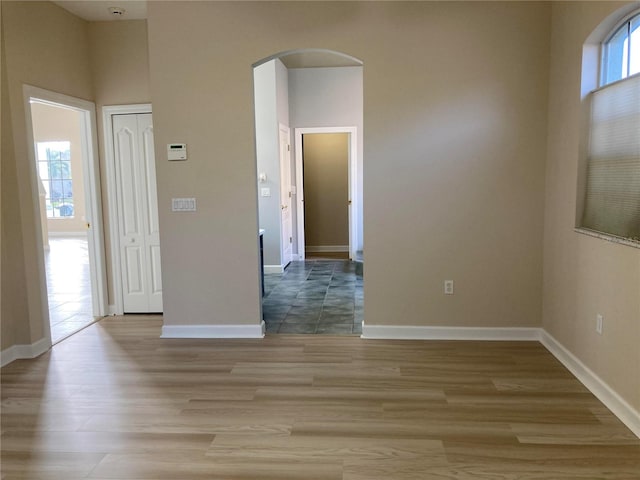 unfurnished room featuring plenty of natural light and light wood-type flooring