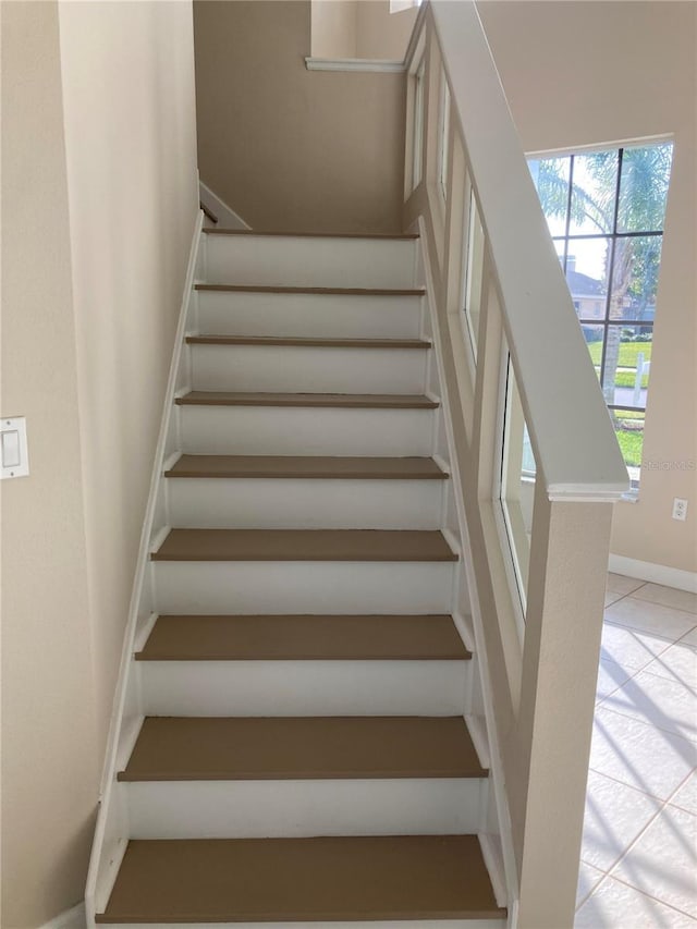 staircase featuring tile patterned flooring