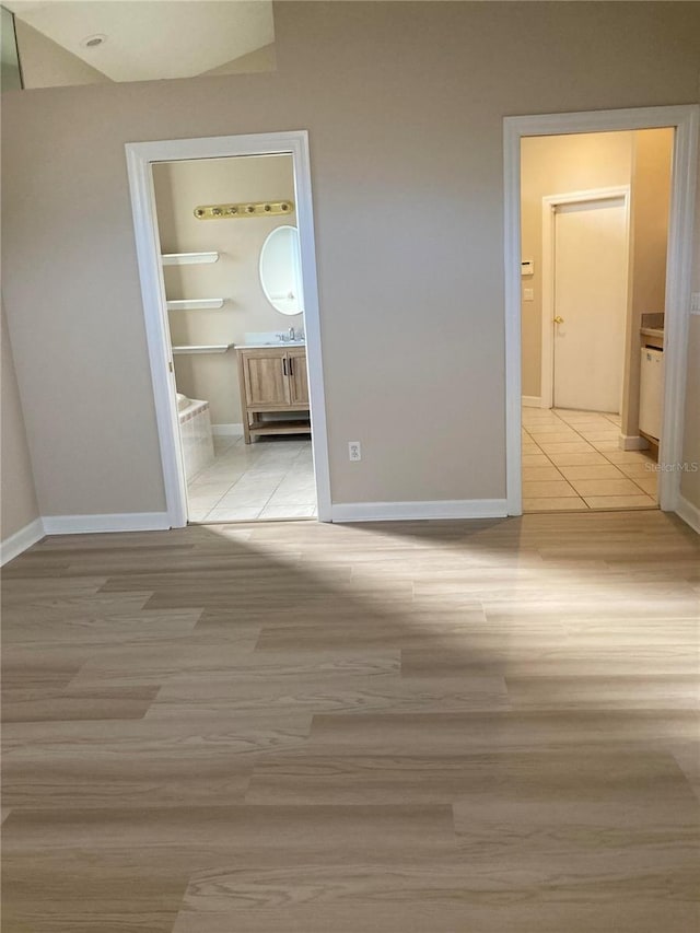 corridor with light hardwood / wood-style flooring