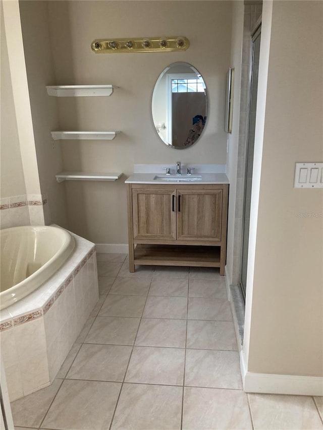 bathroom with tile patterned floors, vanity, and separate shower and tub