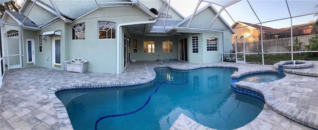 view of pool featuring an in ground hot tub, a patio, and a lanai