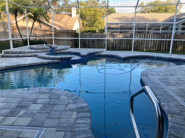 view of pool with an in ground hot tub