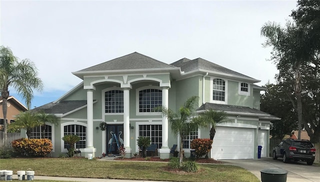 view of front of house featuring a front lawn and a garage