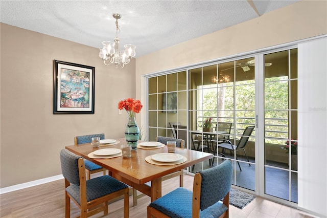 dining area featuring a textured ceiling and a notable chandelier