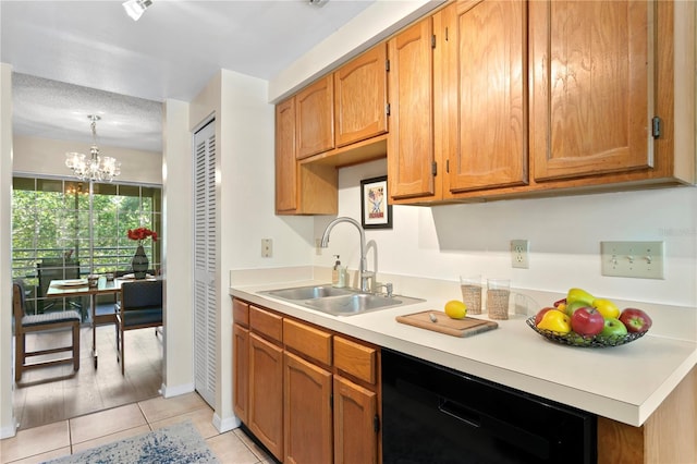 kitchen with sink, light tile patterned floors, an inviting chandelier, dishwasher, and hanging light fixtures