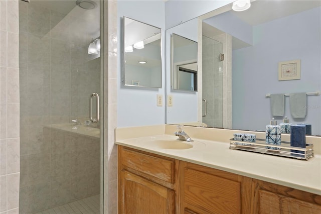 bathroom with vanity and a shower with door