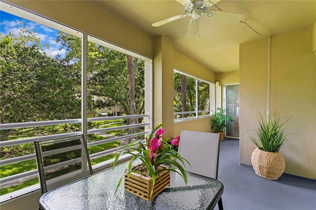 sunroom with ceiling fan and plenty of natural light