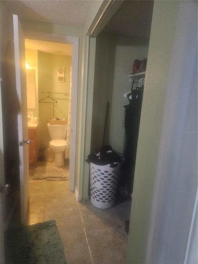 bathroom featuring tile patterned floors, vanity, and toilet