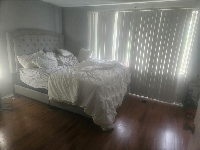 bedroom with dark hardwood / wood-style floors