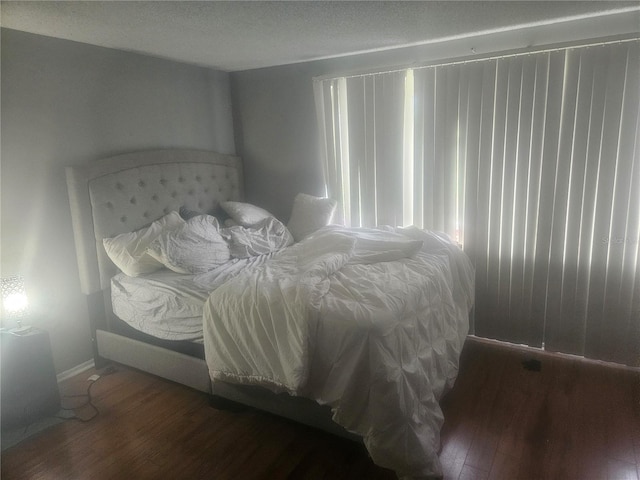 bedroom featuring dark hardwood / wood-style flooring