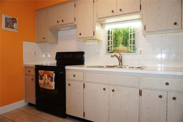 kitchen featuring light brown cabinetry, tasteful backsplash, sink, electric range, and light tile patterned flooring